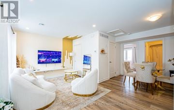 Niagara Falls (Downtown) townhouse for rent - A living room with a white couch and a television.