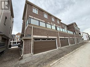 Markham townhouse for rent - A building with the number 90 on it has a brown garage door.