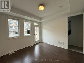 Markham townhouse for rent - A room with a window, door, and a light on the ceiling.