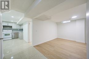 Markham (Milliken Mills East) apartment for rent - A spacious room with wooden flooring and white walls.