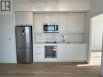Toronto (Henry Farm) condo for rent - A kitchen with white cabinets and a stainless steel refrigerator.
