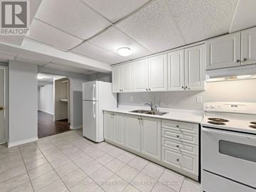 Halton Hills (Georgetown) multi-family for rent - A kitchen with white cabinets and appliances.