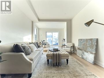 Hamilton (Industrial Sector) apartment for rent - A well-lit, spacious living room with a large sofa and a coffee table.