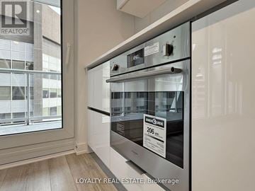 Toronto (Kensington-Chinatown) condo for rent - A stainless steel oven with a control panel and a digital display is in a modern kitchen.