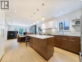 Vancouver apartment for rent - A modern kitchen with a large island and pendant lights.