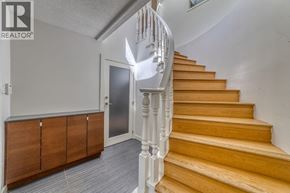 Vancouver apartment for rent - A staircase with a wooden handrail and a grey wall.