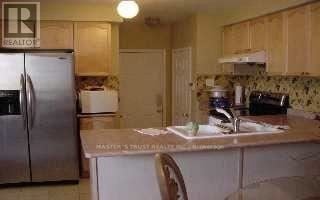 Markham (Wismer) apartment for rent - A kitchen with a refrigerator and a sink.