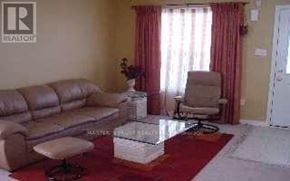 Markham (Wismer) apartment for rent - A living room with a couch, chair, and a rug.