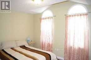 Markham (Wismer) apartment for rent - A bedroom with two beds and a window with curtains.