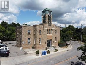Halton Hills (Georgetown) multi-family for rent - A building with a clock tower is for sale.