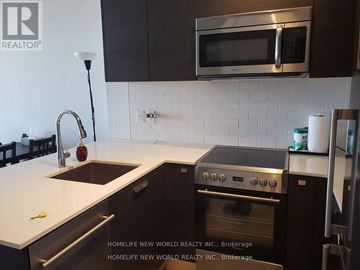 Toronto (Bay Street Corridor) condo for rent - A modern kitchen with a stainless steel oven and microwave above the counter.