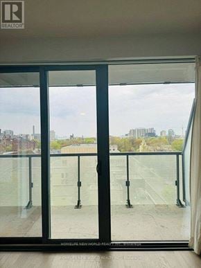 Toronto (Bay Street Corridor) condo for rent - A balcony with glass doors leading to a cityscape.