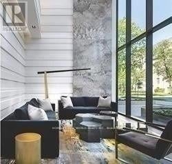 Toronto (Bay Street Corridor) condo for rent - A living room with a couch, a table, and a large window.