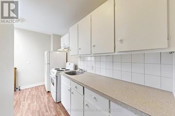Halton Hills (Georgetown) apartment for rent - A kitchen with white cabinets and a white refrigerator.