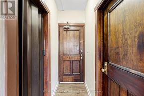 Halton Hills (Georgetown) apartment for rent - A hallway with a wooden door and a brown door on the right.