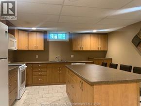 Lasalle apartment for rent - A kitchen with wooden cabinets and a granite countertop.
