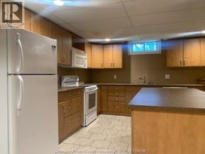 Lasalle apartment for rent - A kitchen with wooden cabinets and a white refrigerator.