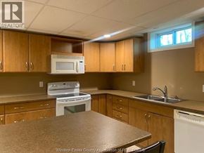 Lasalle apartment for rent - A kitchen with wooden cabinets and a white oven.