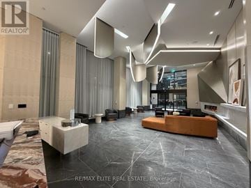 Toronto (Dovercourt-Wallace Emerson-Junction) condo for rent - A spacious living room with a large couch and a long table.