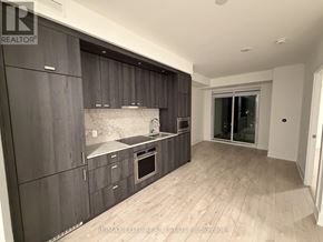Toronto (Dovercourt-Wallace Emerson-Junction) condo for rent - A modern kitchen with dark wood cabinets and a marble backsplash.