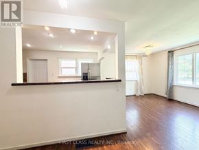 Toronto (Dorset Park) apartment for rent - A spacious room with wooden floors and white walls, with a bar area in the corner.