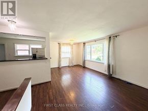 Toronto (Dorset Park) apartment for rent - A room with wooden floors and white walls, with a window covered by curtains.