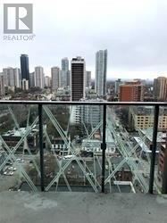 Toronto (Church-Yonge Corridor) condo for rent - A cityscape with a bridge in the foreground and a realtor logo in the corner.