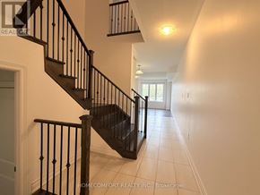 Markham (Cedarwood) apartment for rent - A hallway with a staircase and a light on the wall.