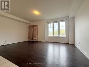 Markham (Cedarwood) apartment for rent - A spacious room with wooden flooring and a large window.