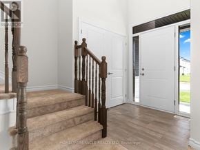 Ottawa apartment for rent - A wooden staircase with a carpeted runner leads to a white door.