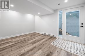 Ottawa apartment for rent - A room with a wooden floor and a white door leading to a balcony.