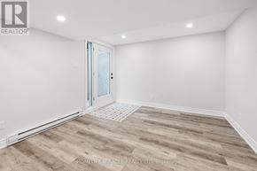 Ottawa apartment for rent - A room with wooden flooring and a glass door.