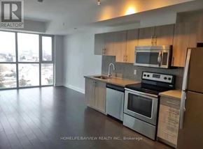 Toronto (Yorkdale-Glen Park) condo for rent - A modern kitchen with a large window overlooking the city.