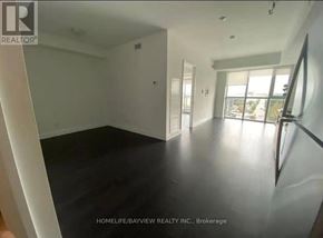 Toronto (Yorkdale-Glen Park) condo for rent - A spacious room with a large window and a view of the outdoors.