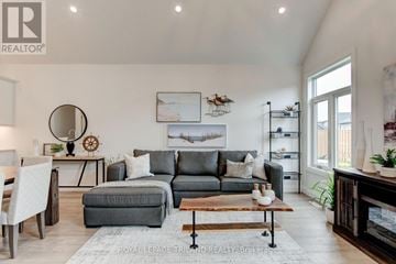 Central Elgin house for rent - A living room with a grey couch and a wooden coffee table.