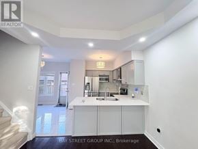 Oakville (Ro River Oaks) townhouse for rent - A kitchen area with white cabinets and a countertop.