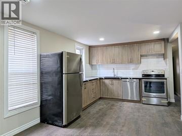 Windsor duplex for rent - A kitchen with a refrigerator, oven, and stove.