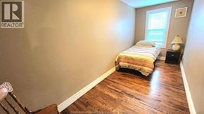 Windsor duplex for rent - A bedroom with a bed, a chair, and a lamp.