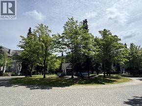 Richmond apartment for rent - A cobblestone road leads through a park with trees and a house in the background.