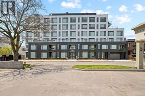 Ottawa apartment for rent - A modern building with a parking lot in front.