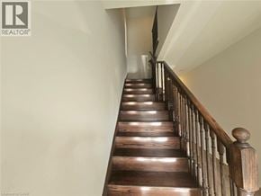 Hamilton townhouse for rent - A wooden staircase with a railing on the side.