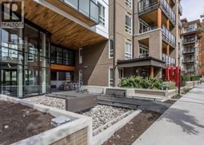Vancouver apartment for rent - A modern building with a glass entrance and a sign that reads "REALTOR".
