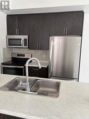 Hamilton (Hamilton Beach) apartment for rent - A modern kitchen with a stainless steel refrigerator and a double sink.