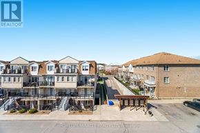 Toronto (Humbermede) townhouse for rent - A real estate company logo is displayed on a building in a residential area.