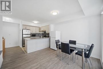 Toronto (Humbermede) townhouse for rent - A modern kitchen with a dining table and chairs.