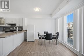 Toronto (Humbermede) townhouse for rent - A well-lit kitchen with a dining table set for four.