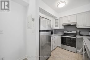 Toronto (Humbermede) townhouse for rent - A kitchen with a refrigerator, oven, and microwave.