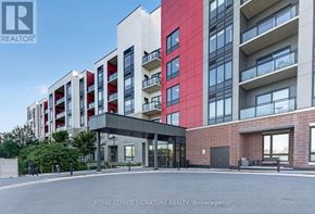Oakville (Go Glenorchy) condo for rent - A modern multi-story building with a glass entrance and a brick wall.