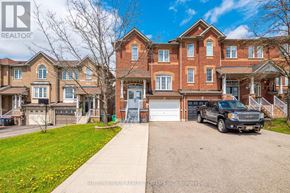 Mississauga (Meadowvale Village) townhouse for rent - A large red brick house with a black truck parked in front.