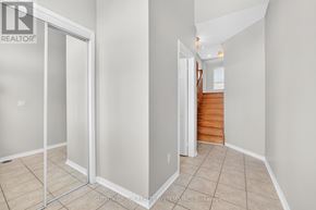 Mississauga (Meadowvale Village) townhouse for rent - A room with a glass door and a wooden staircase.